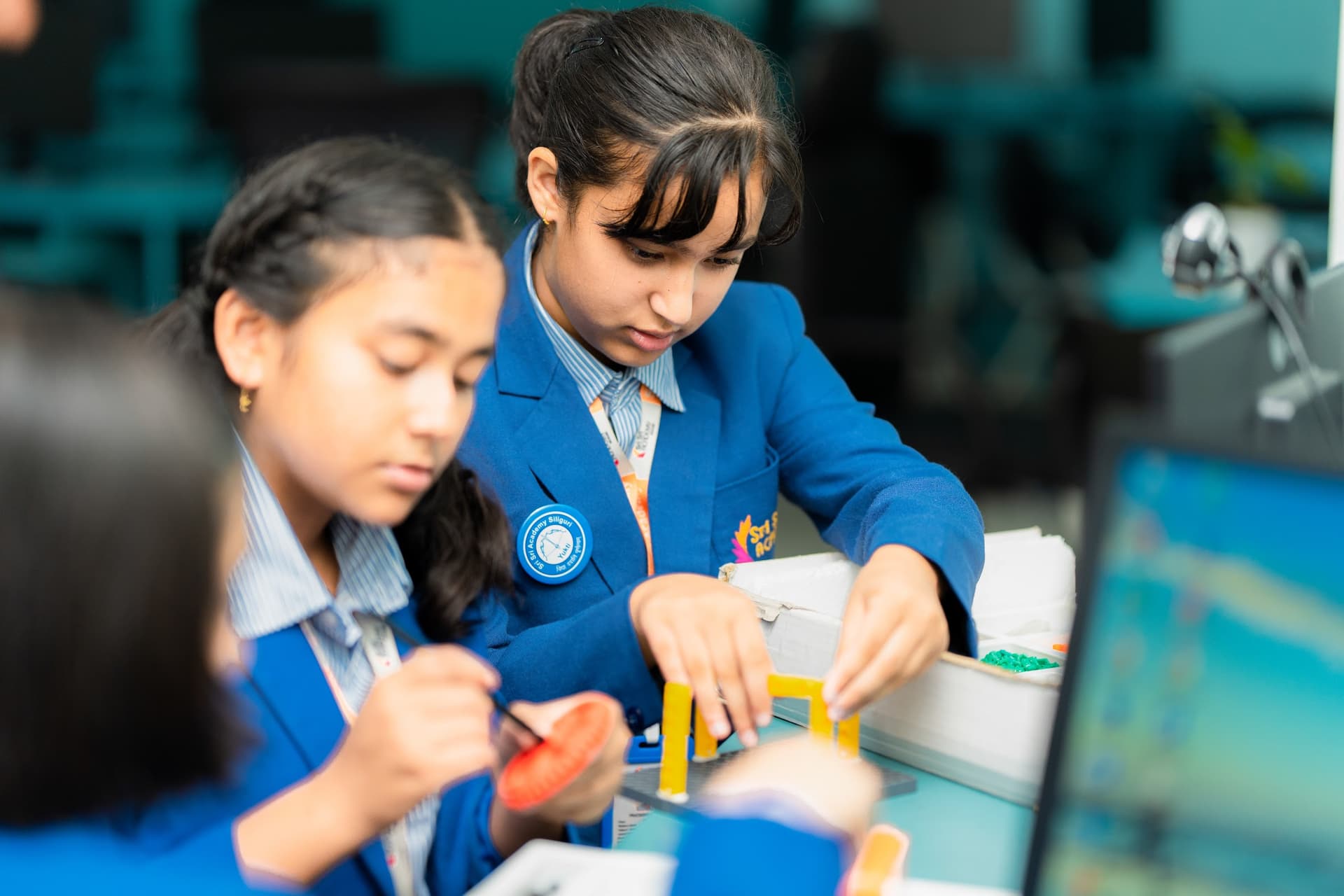 Students collaborating on a hands-on project at Sri Sri Academy