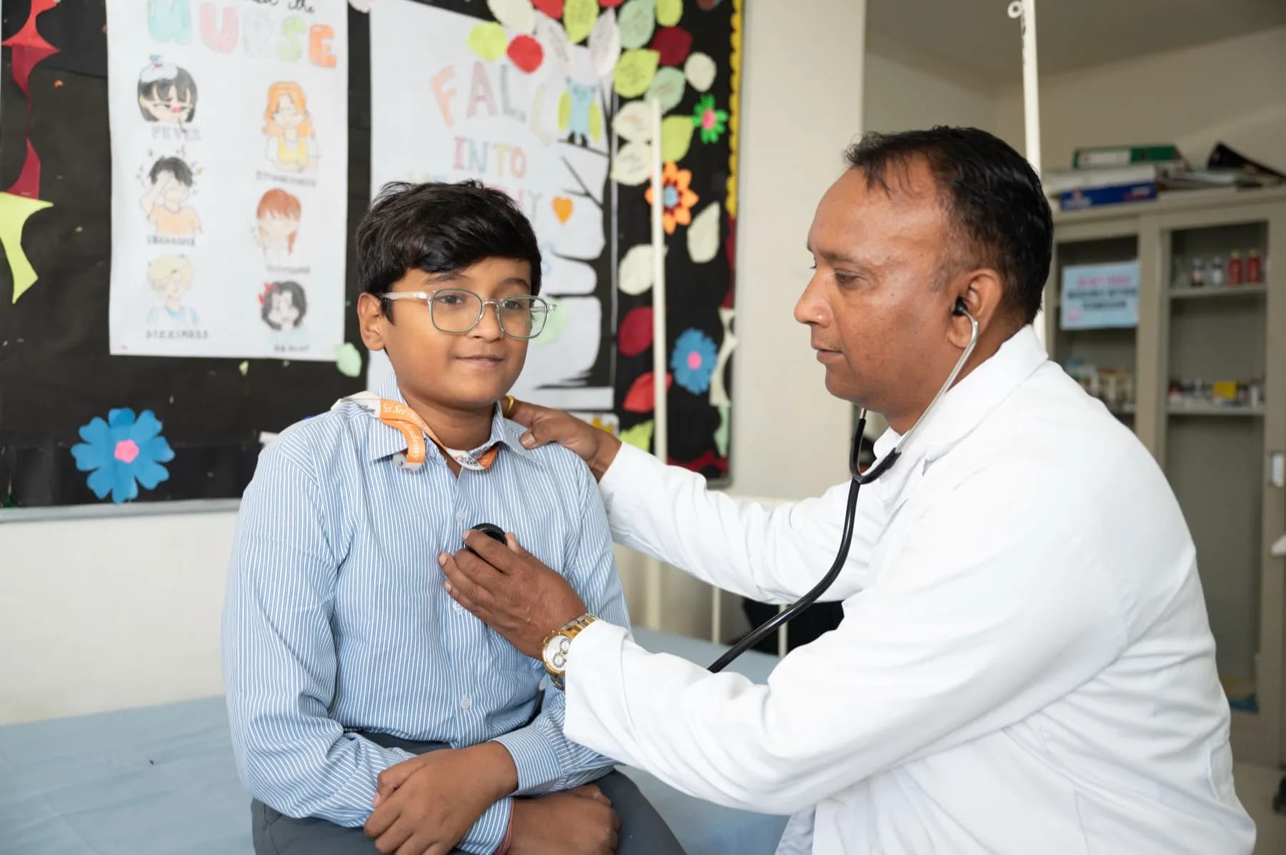 The campus doctor examining a student in the hostel infirmary