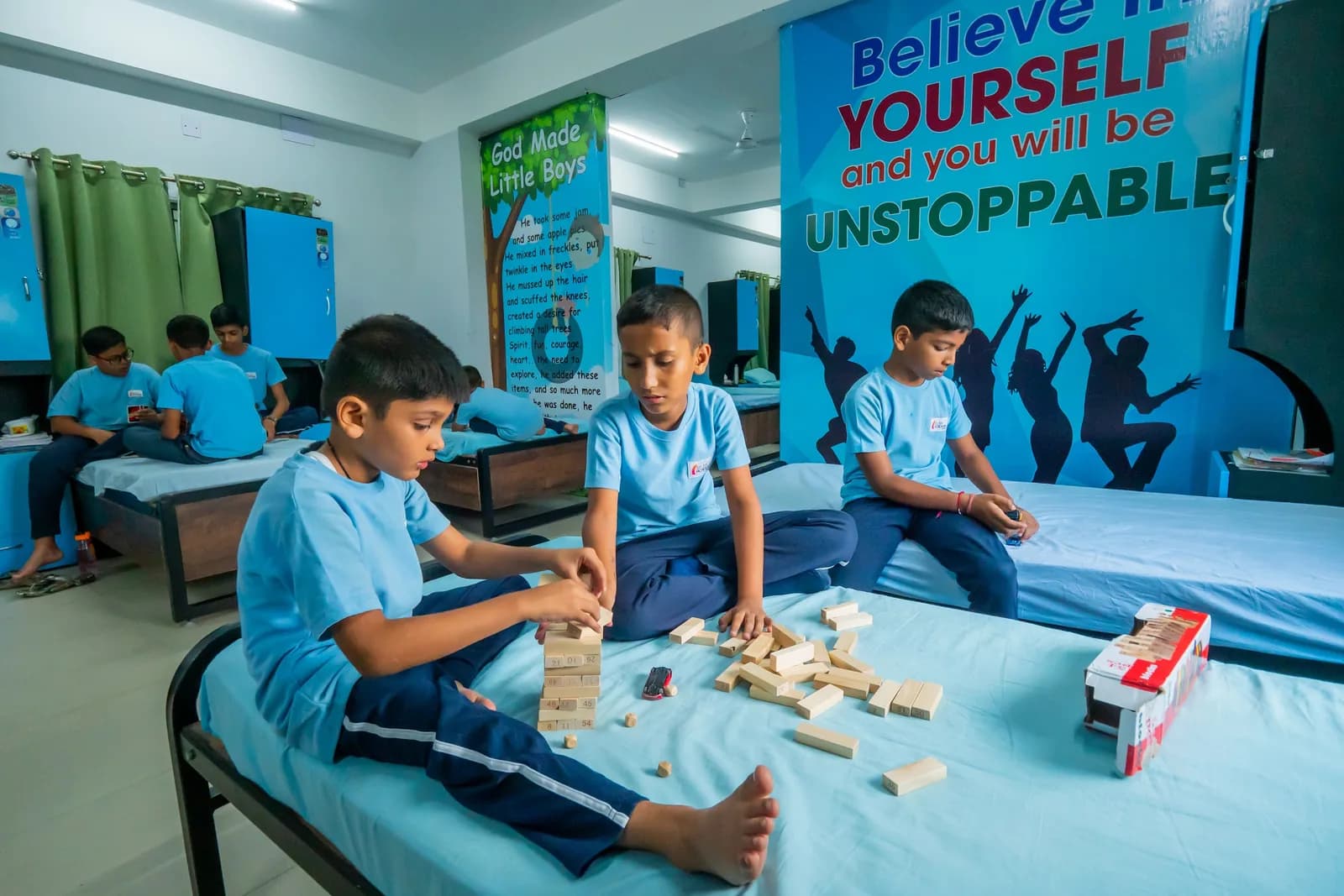 Boarders playing a block game on a bed in the boys' hostel dormitory