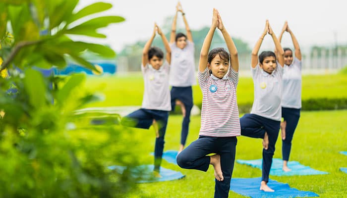 Students practicing yoga at Sri Sri Academy