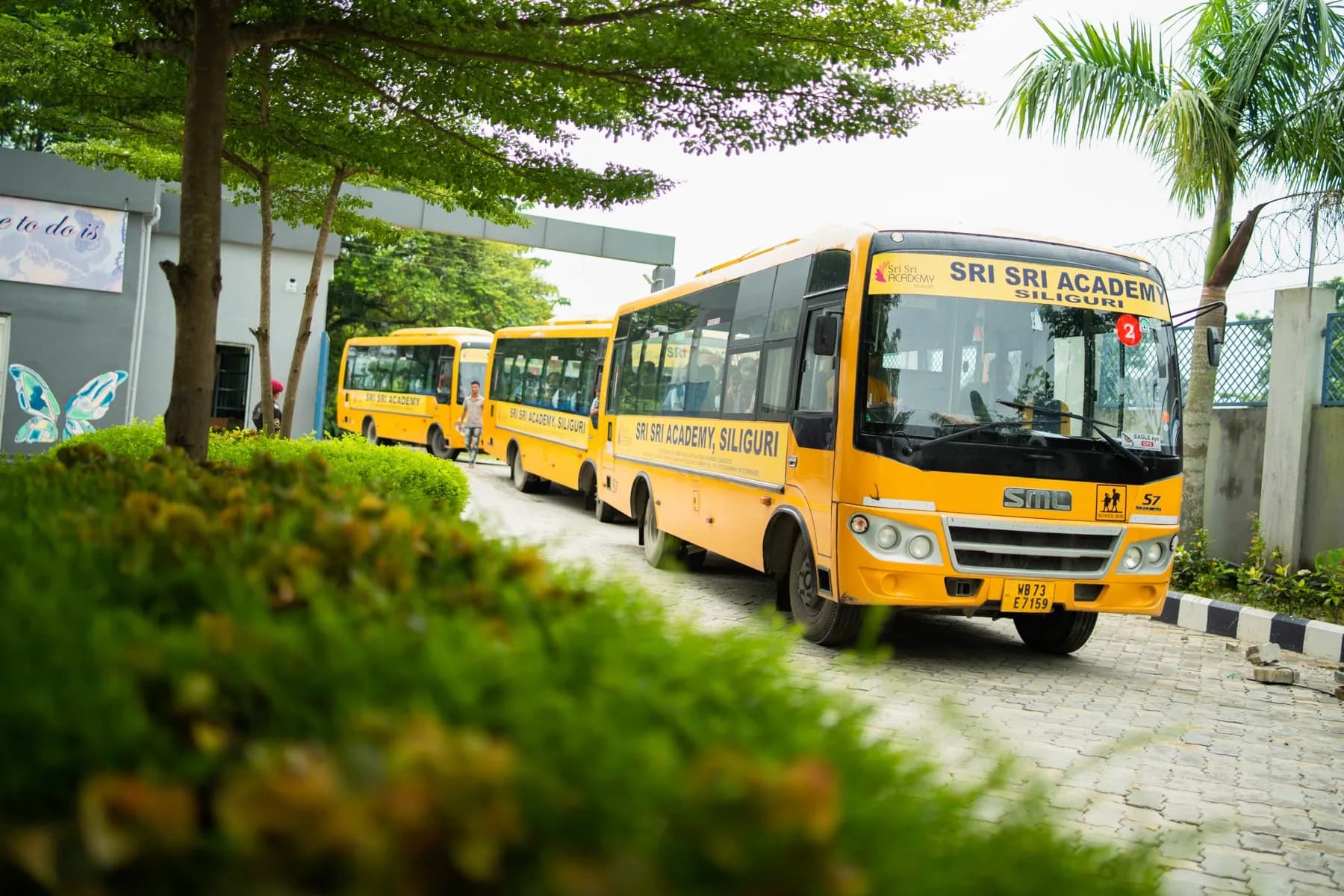 Students boarding a Sri Sri Academy school bus